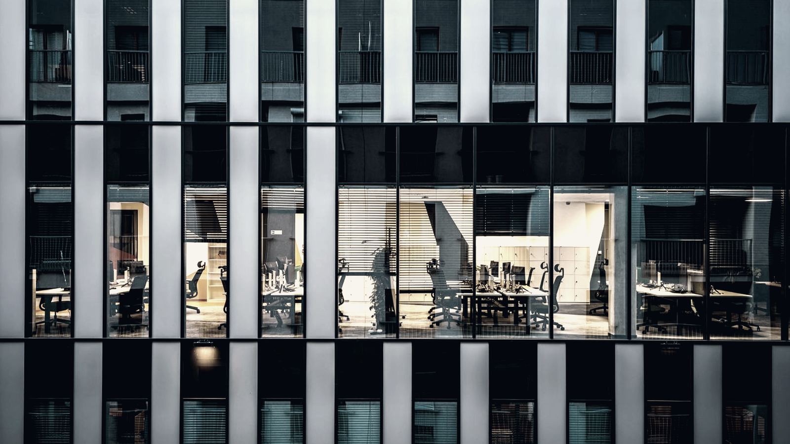Modern office floor viewed through a glazed building facade