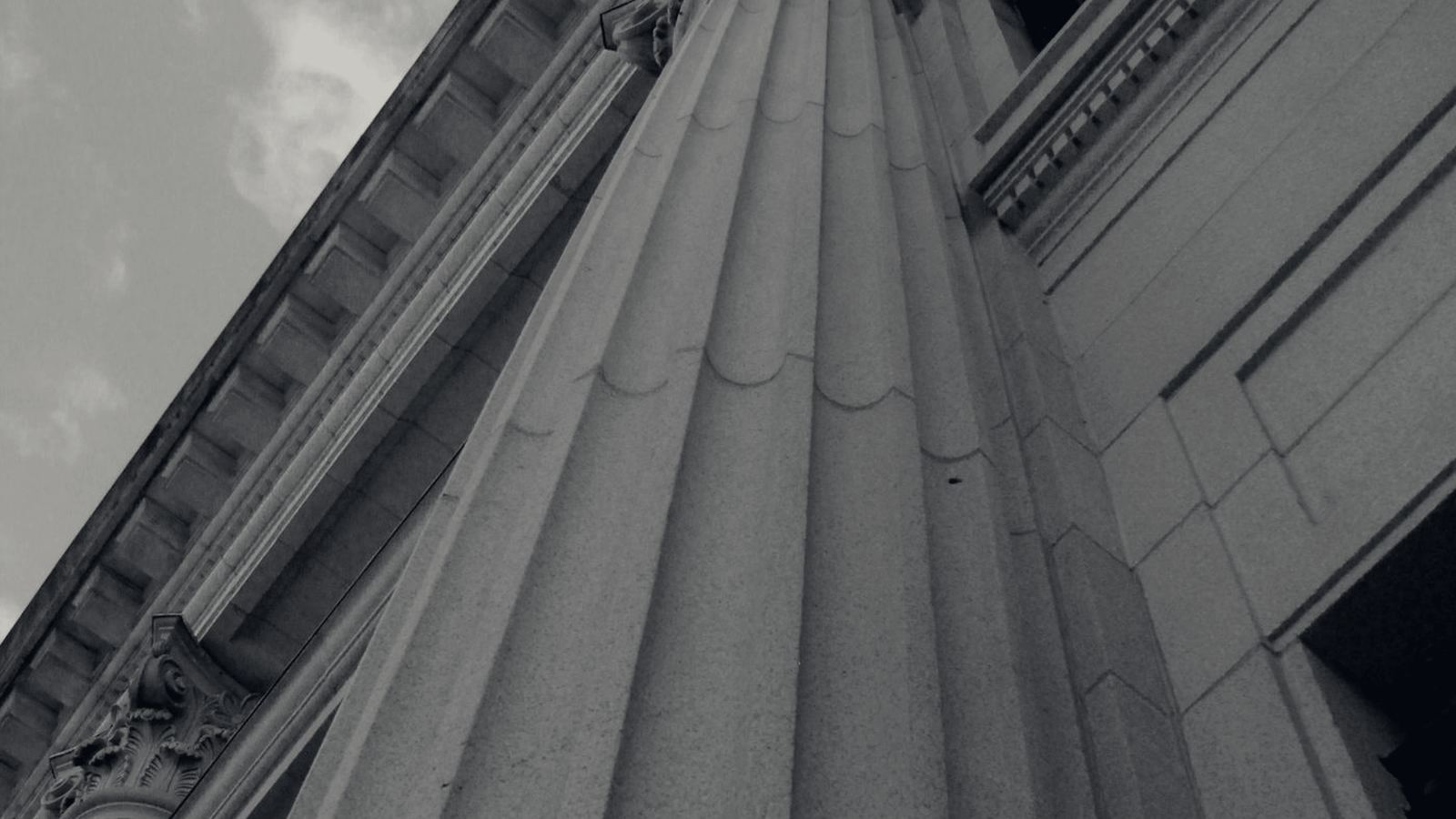 Stone columns of a civic government building photographed from below