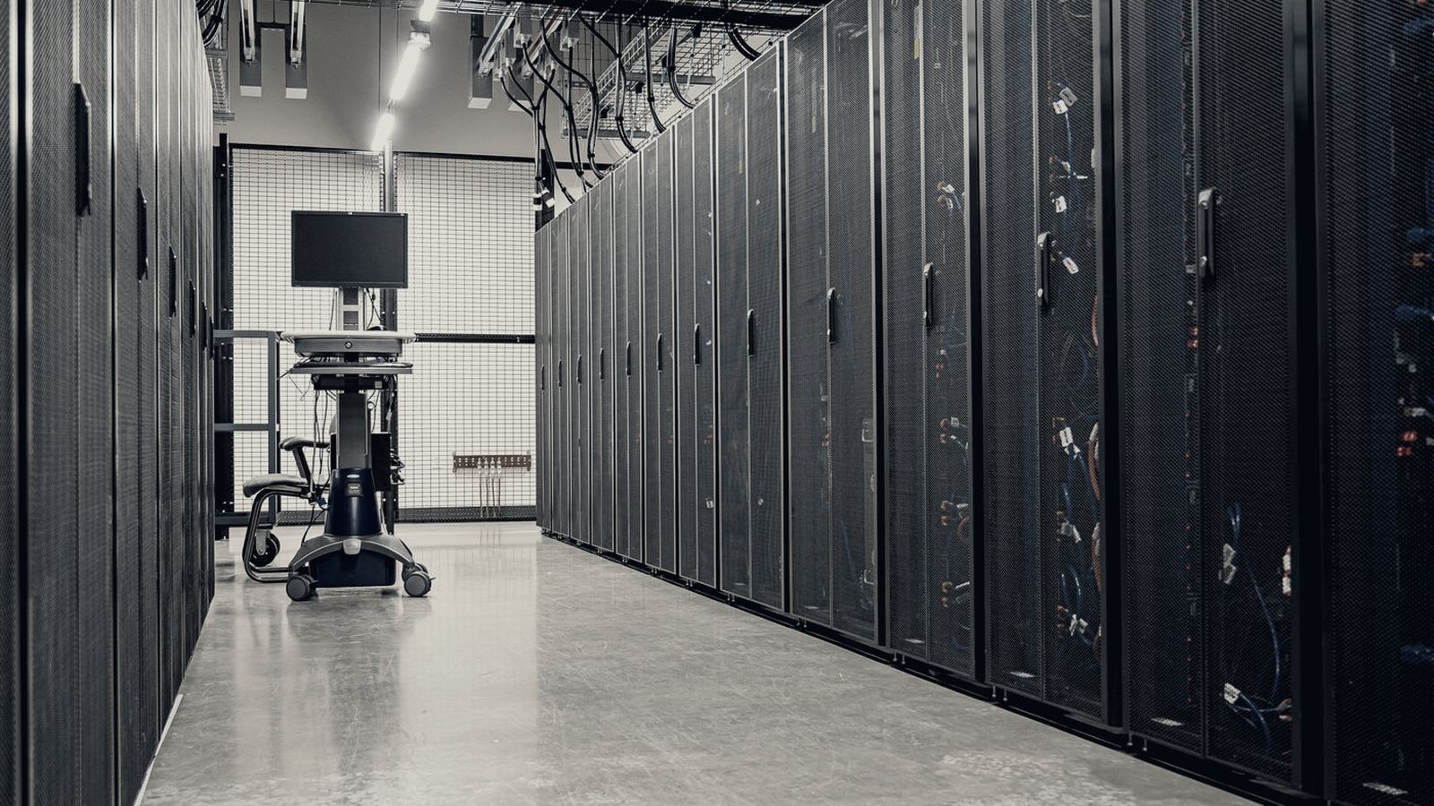 Corridor between rows of server racks inside a data centre