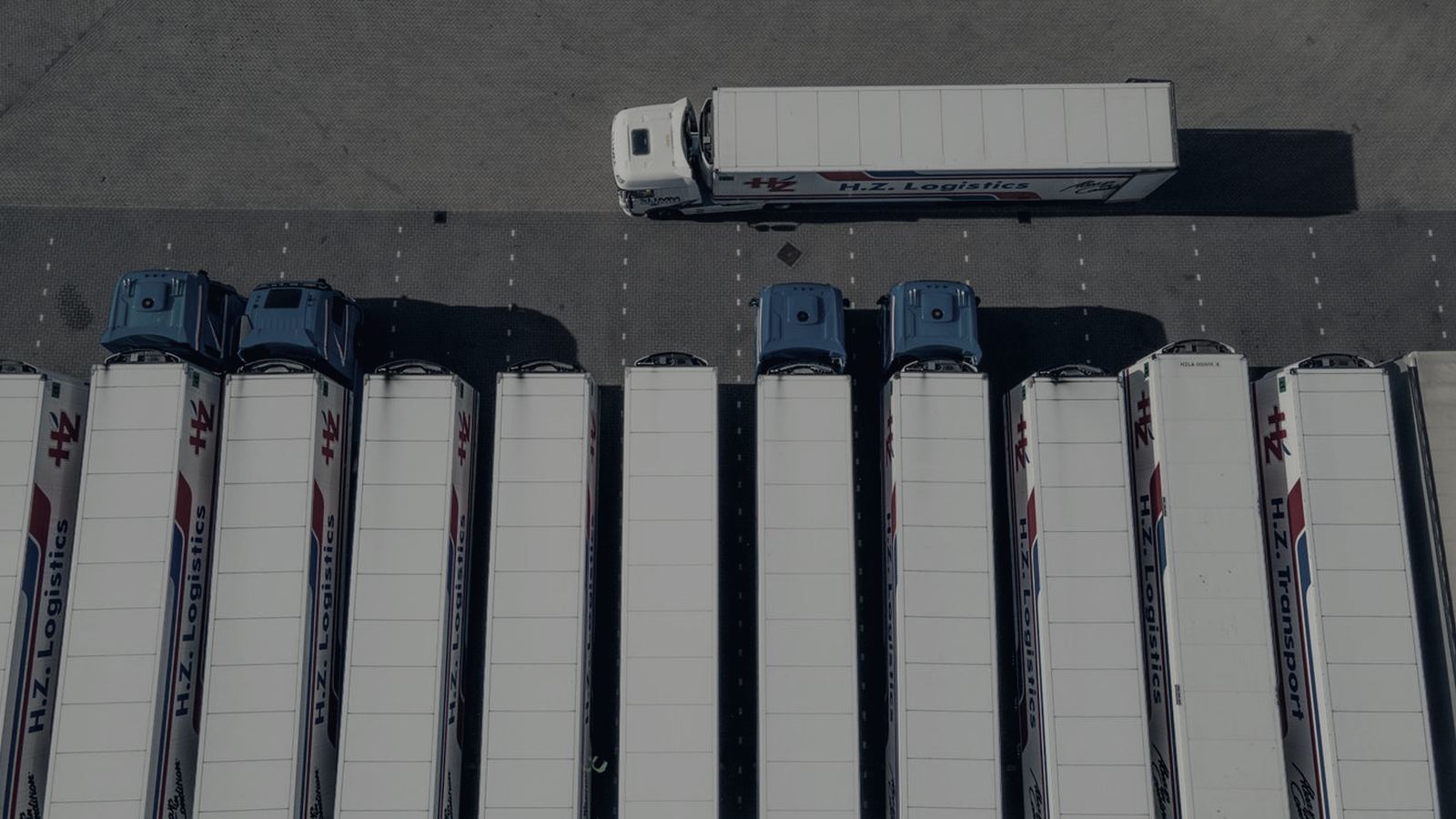 Aerial view of freight trailers lined up at loading docks